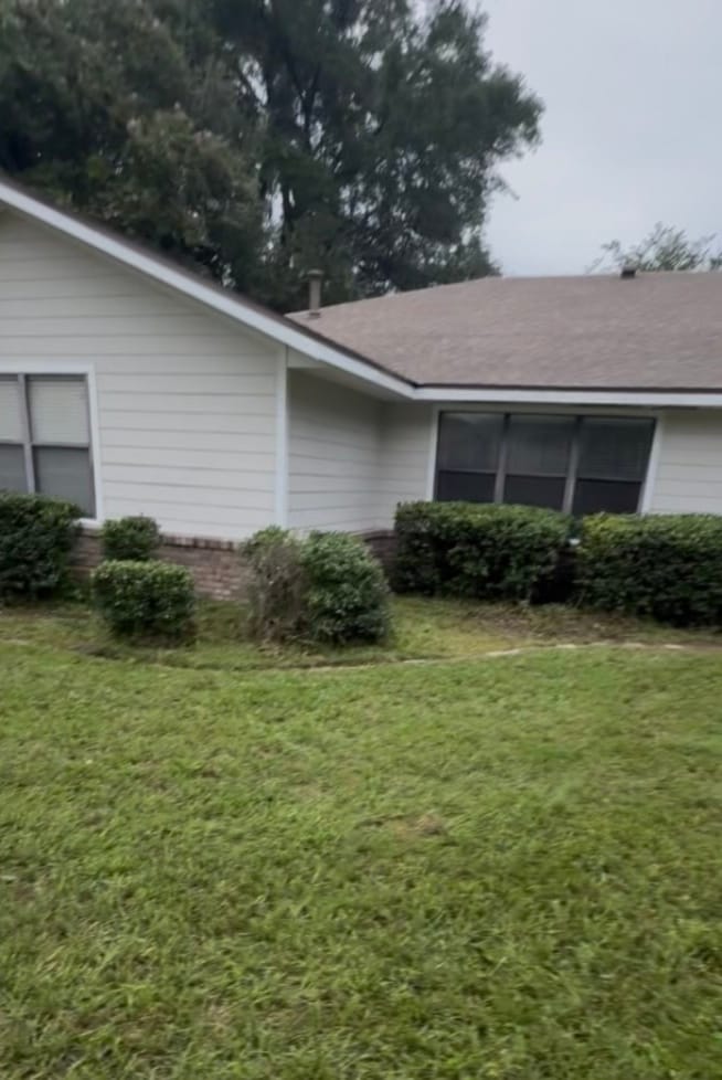 After — the same front cut short and the shrubs trimmed back below the windows.