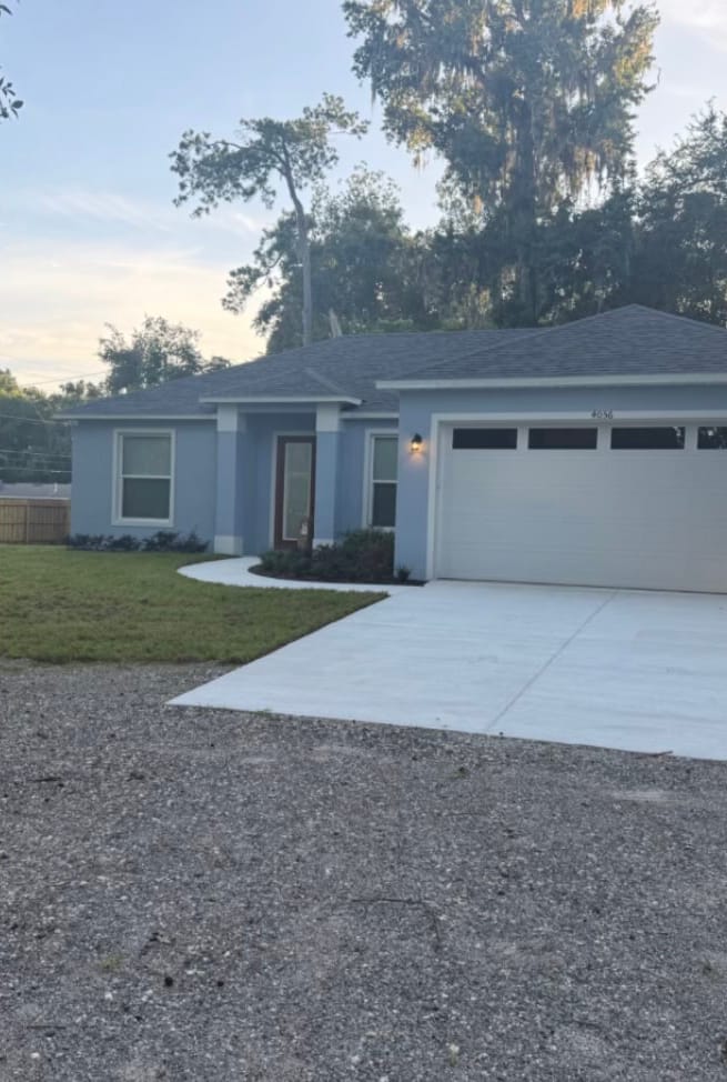 After — the same house with the yard mowed, the walk edged and a fresh mulch bed along the front.